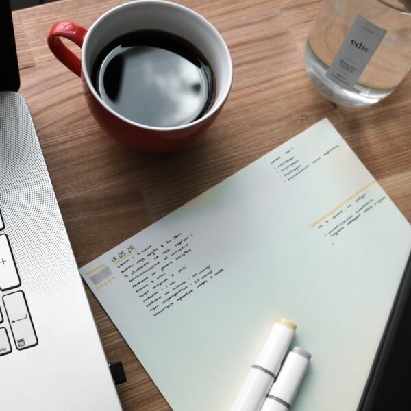 white printer paper beside white ceramic mug on brown wooden table; long-term dividend snowball