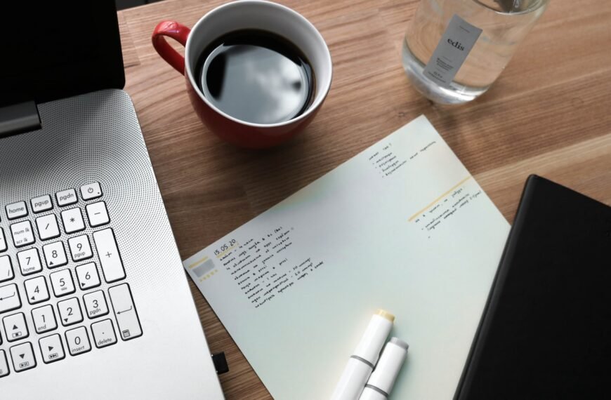 white printer paper beside white ceramic mug on brown wooden table; long-term dividend snowball