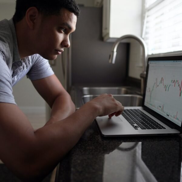 man in gray t-shirt using macbook pro; 7 Tips To Become A Better Investor! dividend investing; dividend snowball with REITs