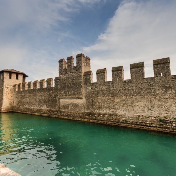 brown concrete building near body of water under blue sky during daytime; high switching costs as an economic moat