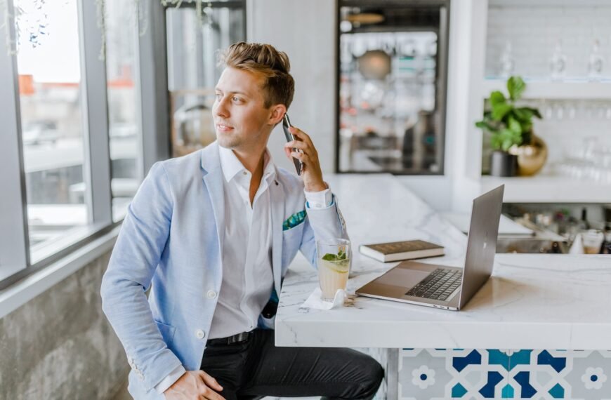 man sitting beside white wooden table; How to Analyze Business Development Companies