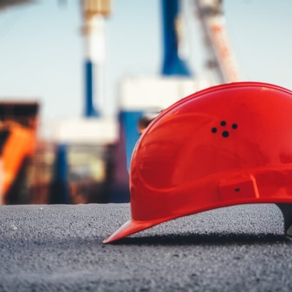 red hard hat on pavement; dividend safety