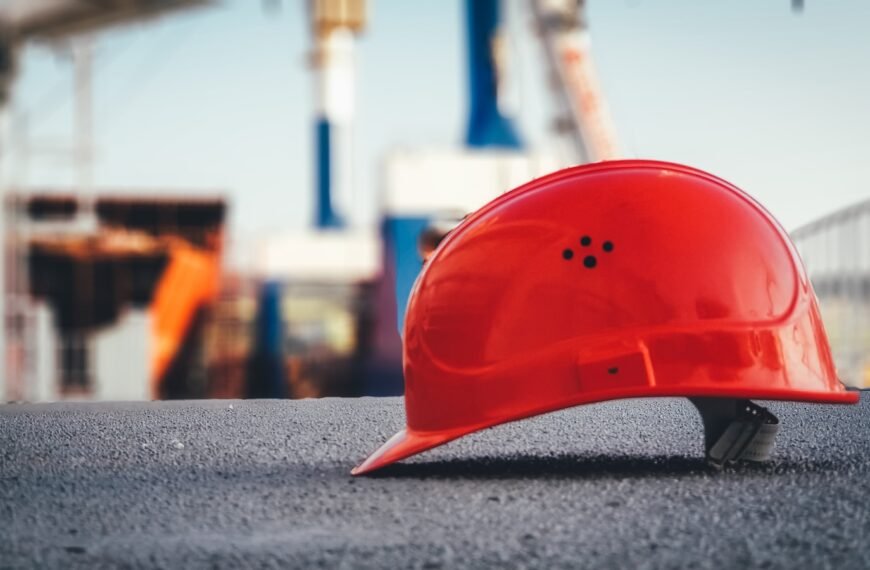 red hard hat on pavement; dividend safety